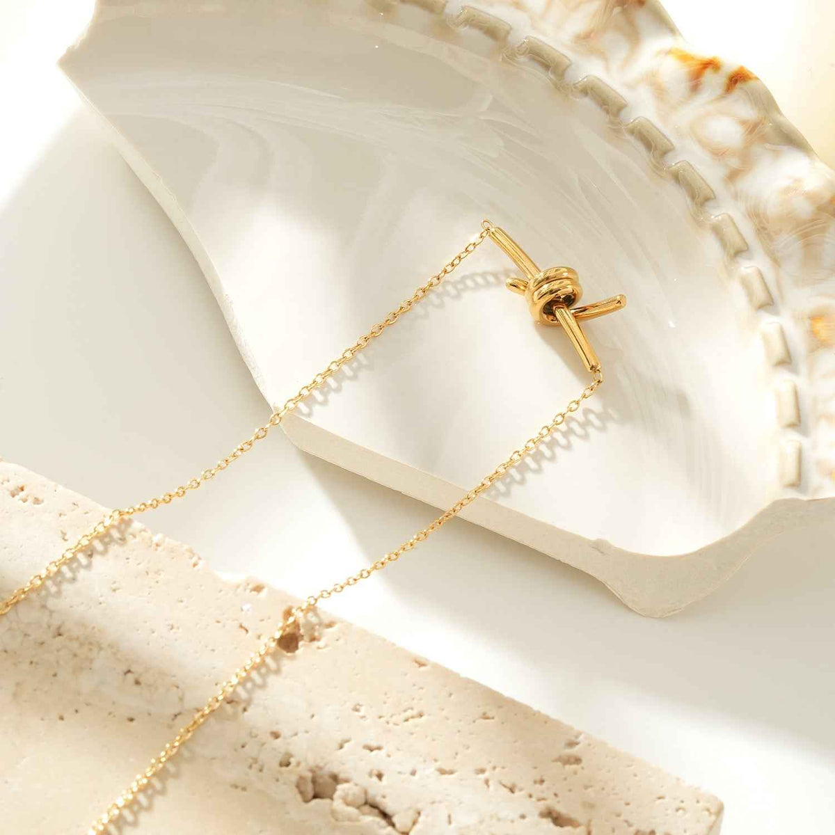LARISA Gold: Bar Pendant Necklace with Knotted Symbol Detail