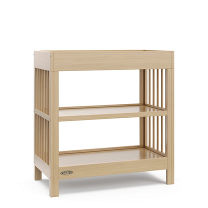 Graco Teddi Changing Table with Water-Resistant Changing Pad (Driftwood) - GREENGUARD Gold Certified, 2 Open Shelves, Includes Bonus Water-Resistant Changing Pad with Safety Strap 🍁 All In One Marketplace Canada