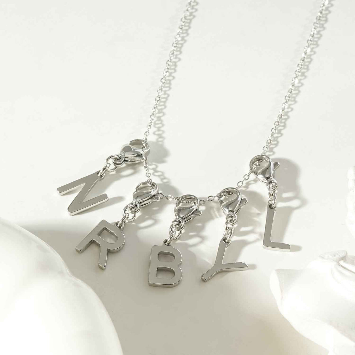 SOLID LETTER MINI CHARMS A–Z in SILVER (White Gold): Dainty Initial Alphabet Pendant for Necklaces & Bracelets — $12.50