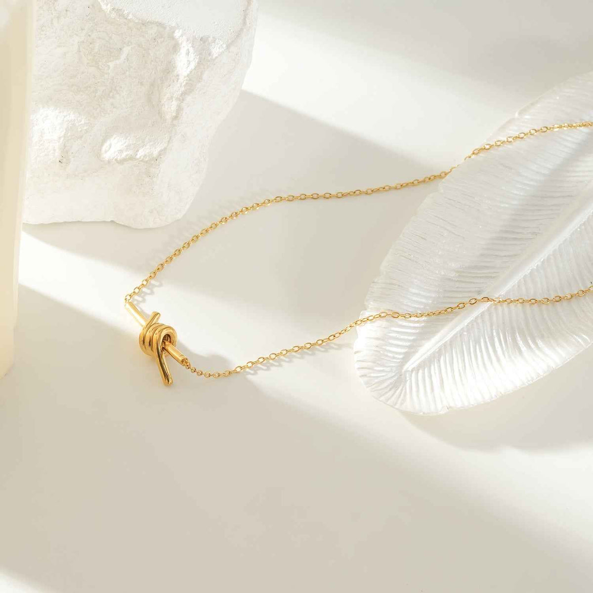LARISA Gold: Bar Pendant Necklace with Knotted Symbol Detail