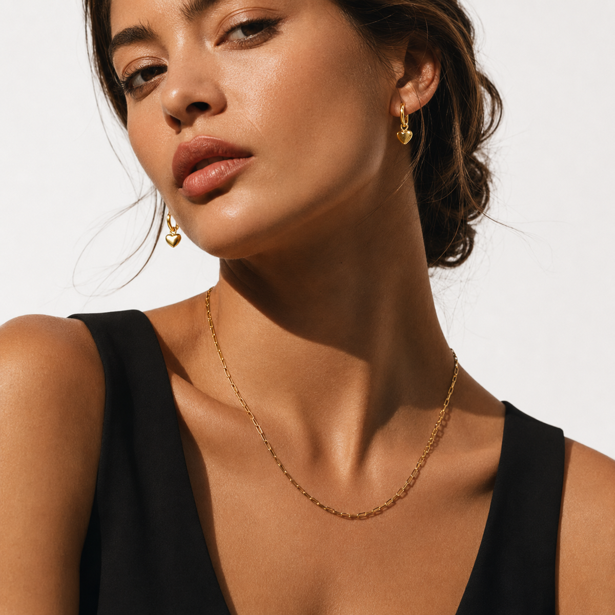 STOWE Gold: Mini Hoop Earrings Anchoring a Heart Shaped Charm